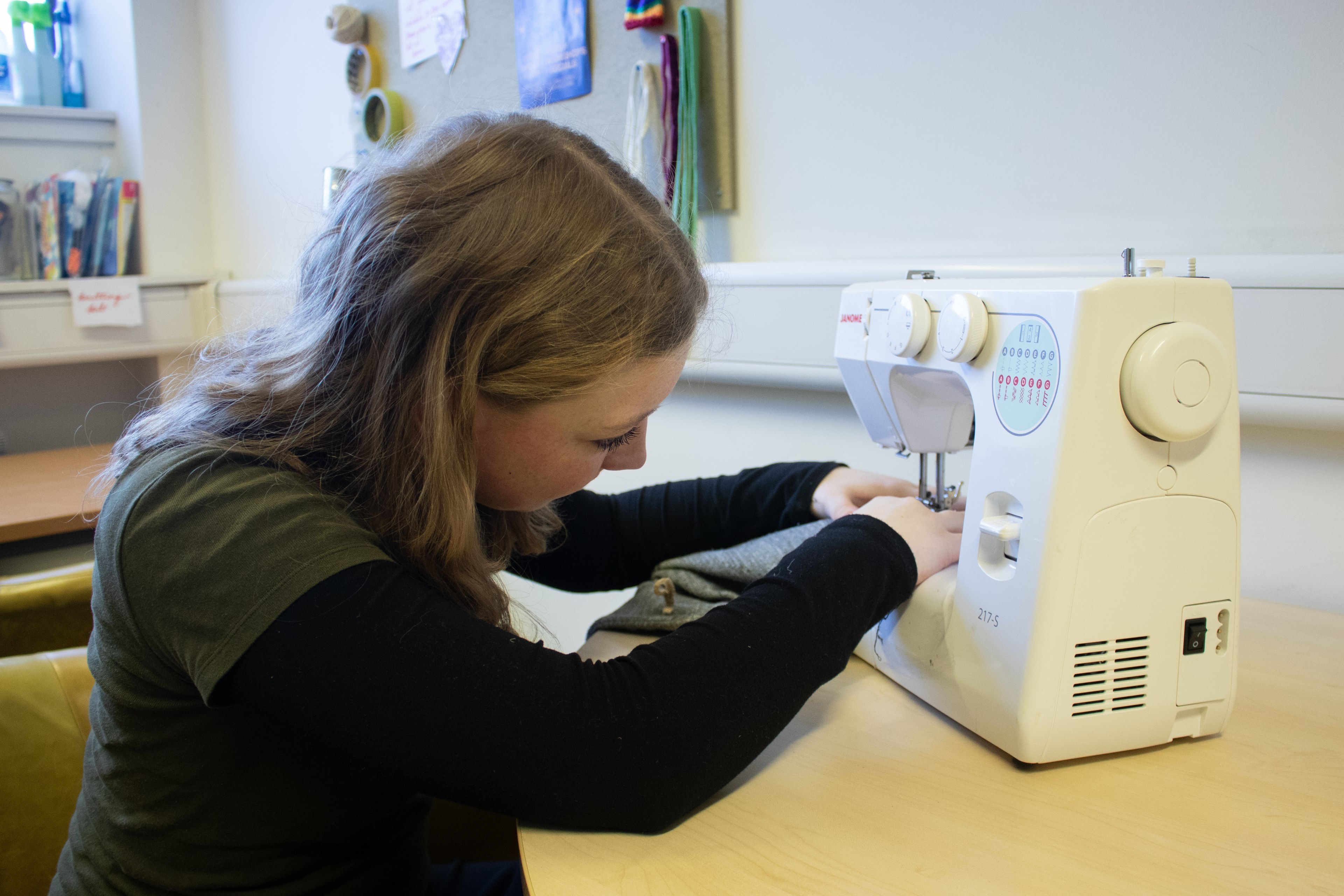 Woman operating a sewing machine inside the crafts rooms